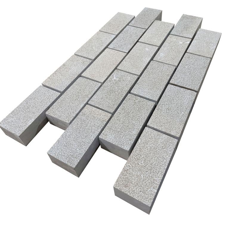 Feature image for Amaza Estrema Limestone Cobblestone - Rectangle - Bush Hammered. The surface finish shown is bush hammered. Dominant colors shown are beige and gray. The color mix creates a warm feeling.