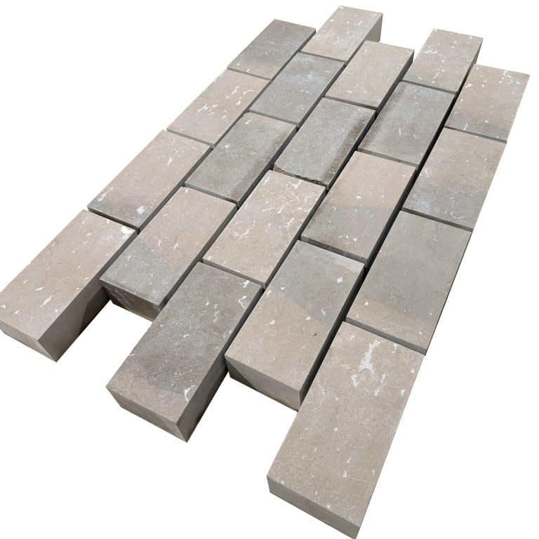 Feature image for Amaza Estrema Limestone Cobblestone - Rectangle - Flamed. The surface finish shown is flamed. Dominant colors shown are beige and gray. The color mix creates a warm feeling.