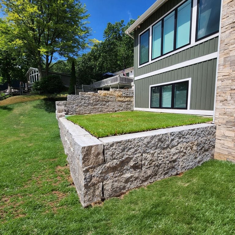 Feature image for Madison Limestone - Splitface Wallstone. The surface finish shown is split-face. The dominant color shown is gray.
