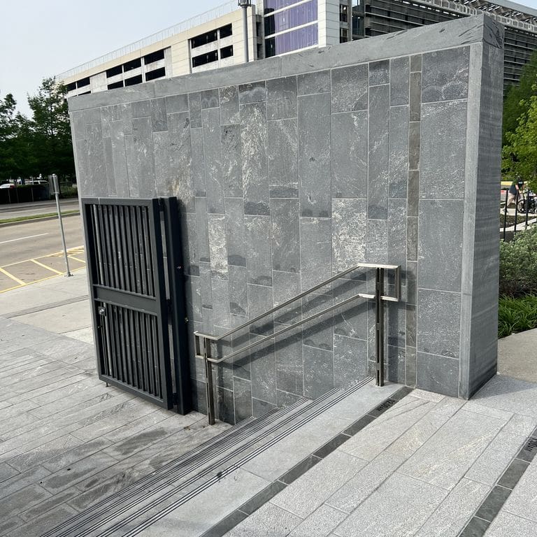 Feature image for Strata Mist Cross-Cut Gneiss - Cut to Size Veneer. The image shows this product being used for full bed veneer and thin veneer. The dominant color shown is gray. The color mix creates a cool feeling.