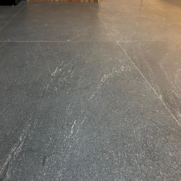 Application image for Strata Mist Cross-Cut Gneiss - Interior Flooring. The image shows this product being used in an interior floor application. Dominant colors shown are black and gray. The color mix creates a cool feeling.