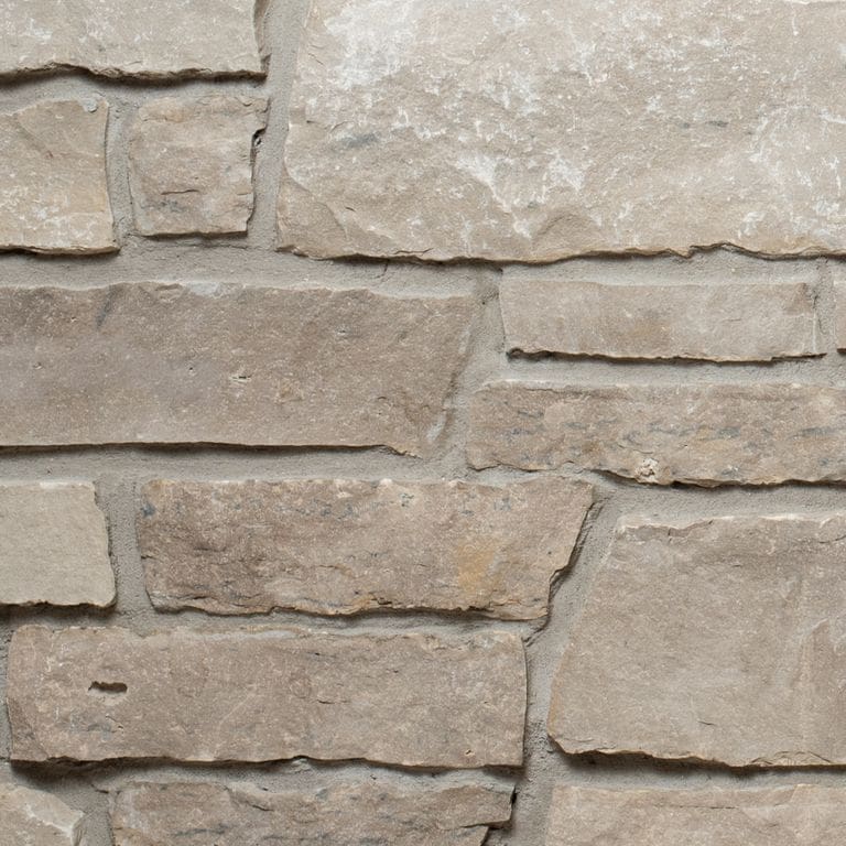 Color/Finish variation image for Lannon Charcoal Limestone - Veneer. The surface finish shown is split-face. Dominant colors shown are gray and tan. The color mix creates a warm feeling.