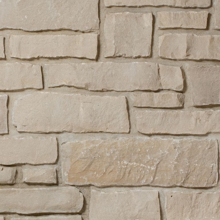 Application image for Lannon Pewter Limestone - Veneer. The image shows this product being used for full bed veneer and thin veneer. The surface finish shown is split-face. The dominant color shown is tan. The color mix creates a warm feeling.