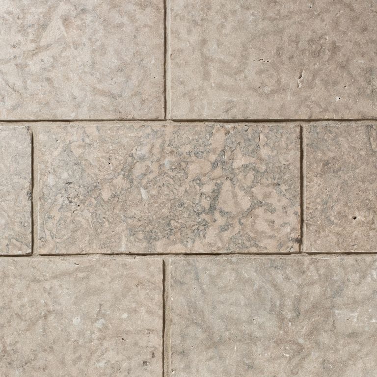 Color/Finish variation image for Madison Limestone - Veneer. The surface finish shown is flamed. Dominant colors shown are beige, gray and tan. The color mix creates a warm feeling.