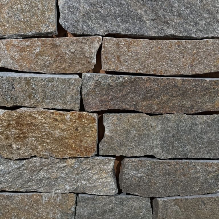 Color/Finish variation image for Quaker Hill Granite - Thin Veneer. The surface finish shown is split-face. Dominant colors shown are brown, gray and tan. The color mix creates a warm feeling.