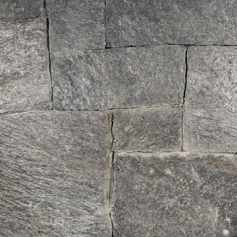 Color/Finish variation image for Black River Mica Granite - Thin Veneer. The surface finish shown is split-face. The dominant color shown is gray. The color mix creates a cool feeling.