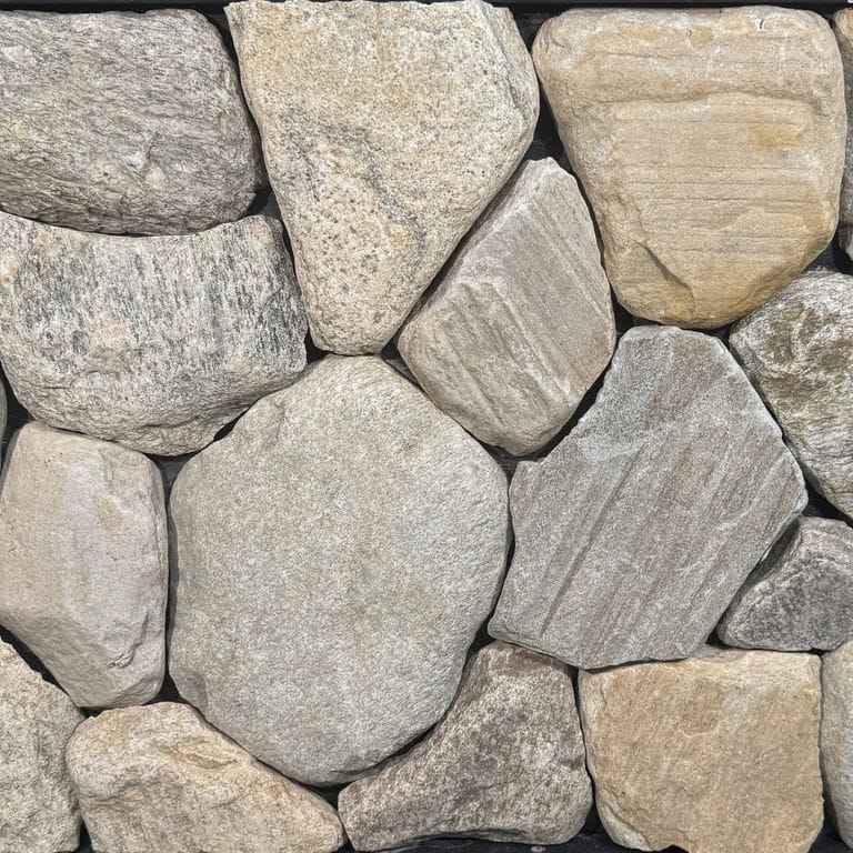 Color/Finish variation image for Connecticut River Rounds - Thin Veneer. The surface finish shown is natural. The dominant color shown is gray. Exhibits "movement" and the color mix creates a warm feeling. Veined and random color patterns.