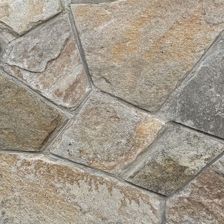 Color/Finish variation image for Copper Mountain Granite - Thin Veneer. The surface finish shown is split-face. Dominant colors shown are gray and tan. The color mix creates a warm feeling.
