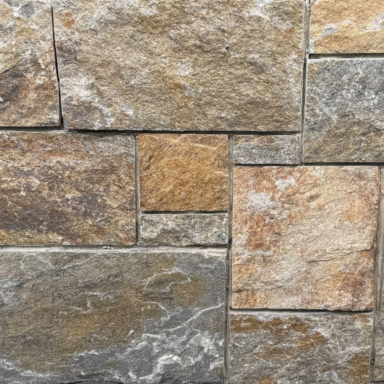 Color/Finish variation image for Copper Mountain Granite - Thin Veneer. The surface finish shown is split-face. Dominant colors shown are brown and tan. The color mix creates a warm feeling.
