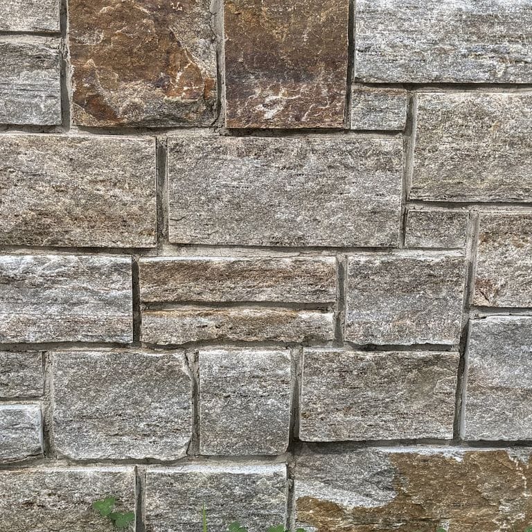 Color/Finish variation image for Copper Mountain Granite - Thin Veneer. The surface finish shown is split-face. Dominant colors shown are gray and tan. The color mix creates a warm feeling.