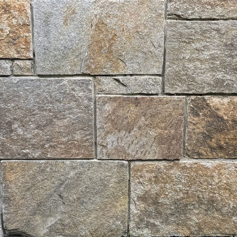 Color/Finish variation image for Copper Mountain Granite - Thin Veneer. The surface finish shown is split-face. Dominant colors shown are gray and tan. The color mix creates a warm feeling.