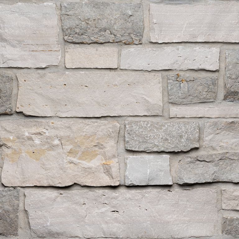 Color/Finish variation image for Nordic Sierra Gray Limestone - Thin Veneer. The surface finish shown is split-face. The dominant color shown is gray. The color mix creates a warm feeling.