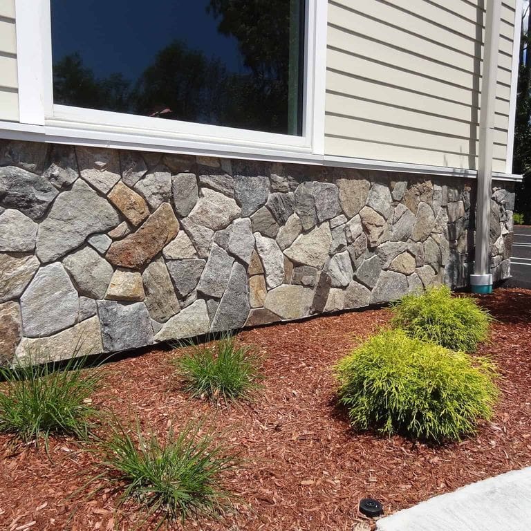 Best close-up image for Boston Blend Granite Veneer - Mosaic. The image shows this product being used in a thin veneer application. The surface finish shown is . Dominant colors shown are brown and gray. The color mix creates a warm feeling.