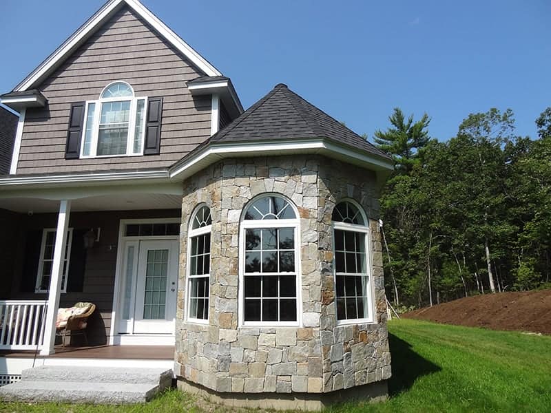 Application image for Newport Mist Granite Veneer - Mosaic. The image shows this product being used in a full bed veneer application. The surface finish shown is . Dominant colors shown are gray and tan. The color mix creates a warm feeling.