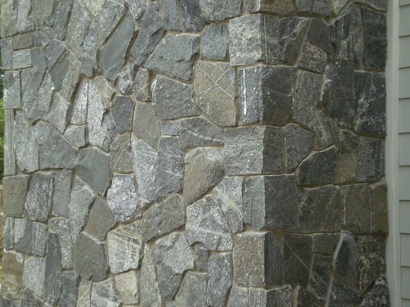 Application image for Greenwich Gray Granite Veneer - Mosaic. The image shows this product being used in a thin veneer application. The surface finish shown is . Dominant colors shown are green and gray.
