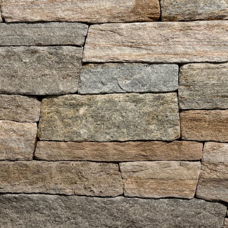 Color/Finish variation image for New England Tan Granite - Thin Veneer. The surface finish shown is split-face. Dominant colors shown are brown and tan. The color mix creates a warm feeling.