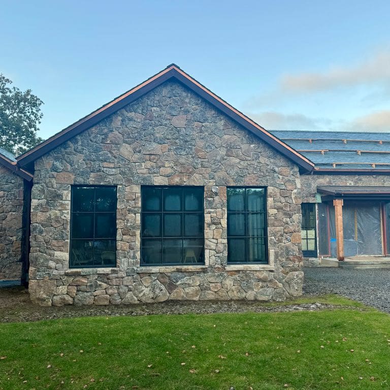 Application image for Montana Moss Rock - Veneer. The image shows this product being used in a full bed veneer application. Dominant colors shown are brown and gray. The color mix creates a warm feeling.