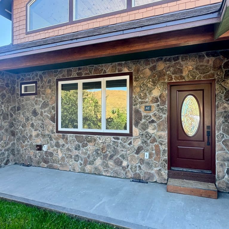 Application image for Montana Moss Rock - Veneer. The image shows this product being used in a full bed veneer application. Dominant colors shown are brown and gray.