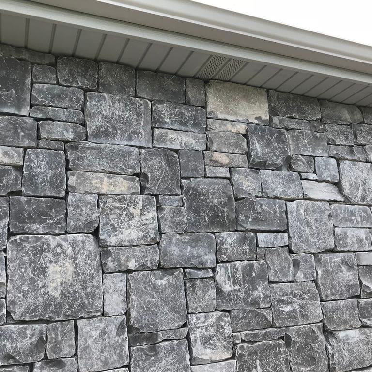 Application image for Mountain Storm Limestone - Veneer. The image shows this product being used for full bed veneer and thin veneer. The dominant color shown is gray. The color mix creates a cool feeling.