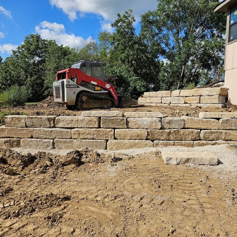 Application image for Great Plains Limestone - Tan - Wallstone. The image shows this product being used for landscape wallstone and retaining wall. The surface finish shown is . Dominant colors shown are brown and tan. The color mix creates a warm feeling.
