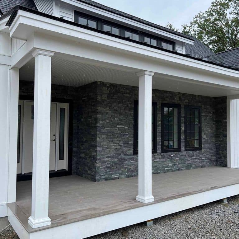 Application image for Greenwich Gray Granite Thin Veneer - Ashlar. The image shows this product being used in a thin veneer application. The surface finish shown is split-face. Dominant colors shown are black and gray. The color mix creates a cool feeling.