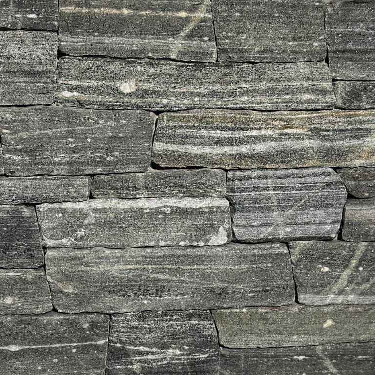 Color/Finish variation image for Greenwich Gray Granite Veneer - Ledge. The surface finish shown is split-face. Dominant colors shown are green and gray. The color mix creates a cool feeling.