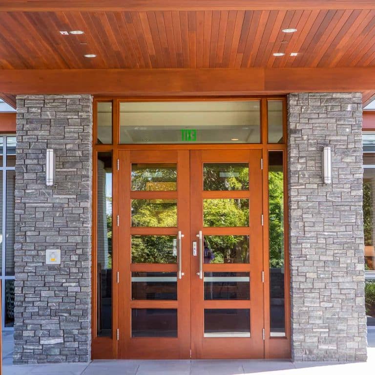 Application image for Greenwich Gray Granite Veneer - Ledge. The image shows this product being used in a full bed veneer application. The surface finish shown is split-face. The dominant color shown is gray. The color mix creates a cool feeling.