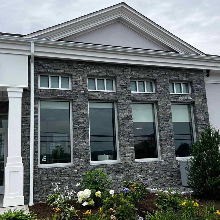 Application image for Greenwich Gray Granite Veneer - Ledge. The image shows this product being used in a full bed veneer application. The surface finish shown is split-face. The dominant color shown is gray. The color mix creates a cool feeling.