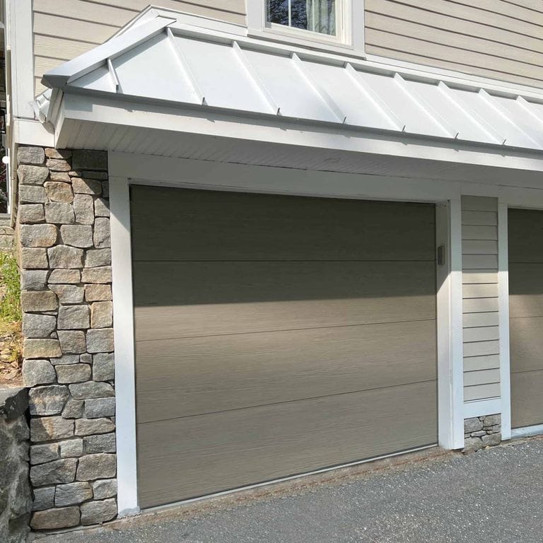 Application image for Newport Mist Granite Veneer - Ashlar. The image shows this product being used in a full bed veneer application. The surface finish shown is split-face. Dominant colors shown are gray and tan. The color mix creates a warm feeling.