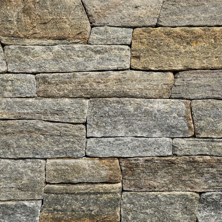 Color/Finish variation image for Newport Mist Granite Veneer - Ledge. The surface finish shown is split-face. Dominant colors shown are gray and tan. The color mix creates a warm feeling.