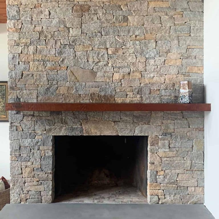 Application image for Newport Mist Granite Veneer - Ledge. The image shows this product being used in a thin veneer application. The surface finish shown is split-face. Dominant colors shown are gray and tan. The color mix creates a warm feeling.