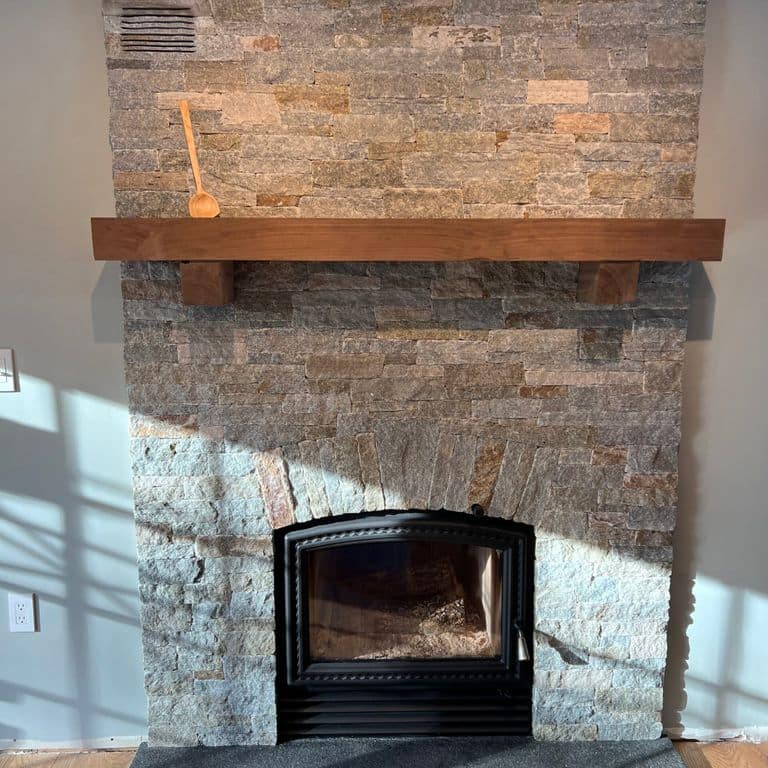 Application image for Newport Mist Granite Veneer - Ledge. The image shows this product being used in a thin veneer application. The surface finish shown is split-face. Dominant colors shown are gray and tan. The color mix creates a warm feeling.