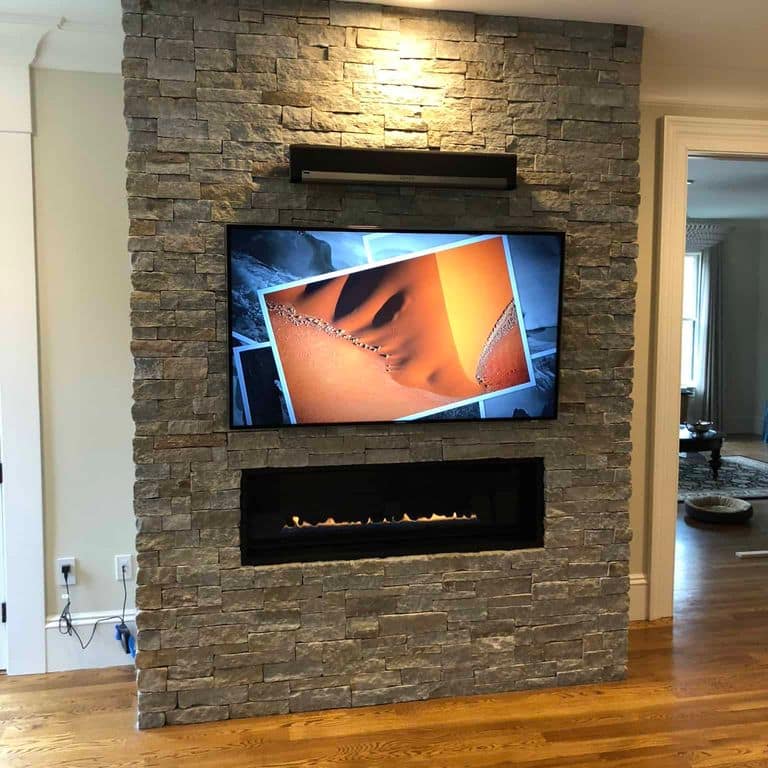 Application image for Newport Mist Granite Veneer - Ledge. The image shows this product being used in a thin veneer application. The surface finish shown is split-face. The dominant color shown is tan. The color mix creates a warm feeling.