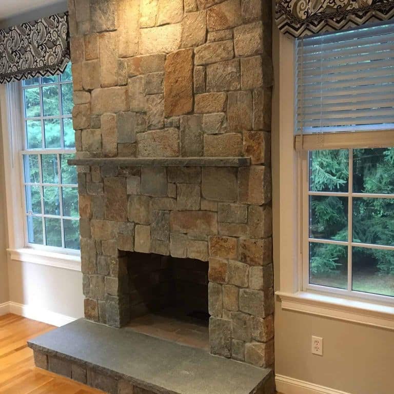 Feature image for Newport Mist Granite Veneer - Square and Rectangle. The image shows this product being used in a thin veneer application. The surface finish shown is split-face. Dominant colors shown are brown, gray and tan.