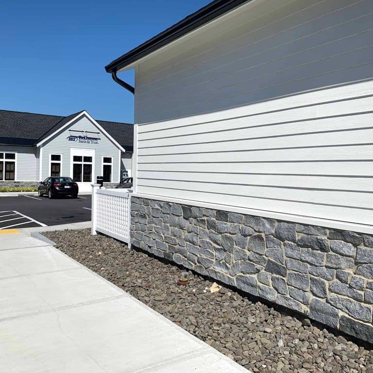 Application image for Oyster Bay Granite Thin Veneer - Ashlar. The image shows this product being used in a thin veneer application. The surface finish shown is split-face. The dominant color shown is gray. The color mix creates a cool feeling.