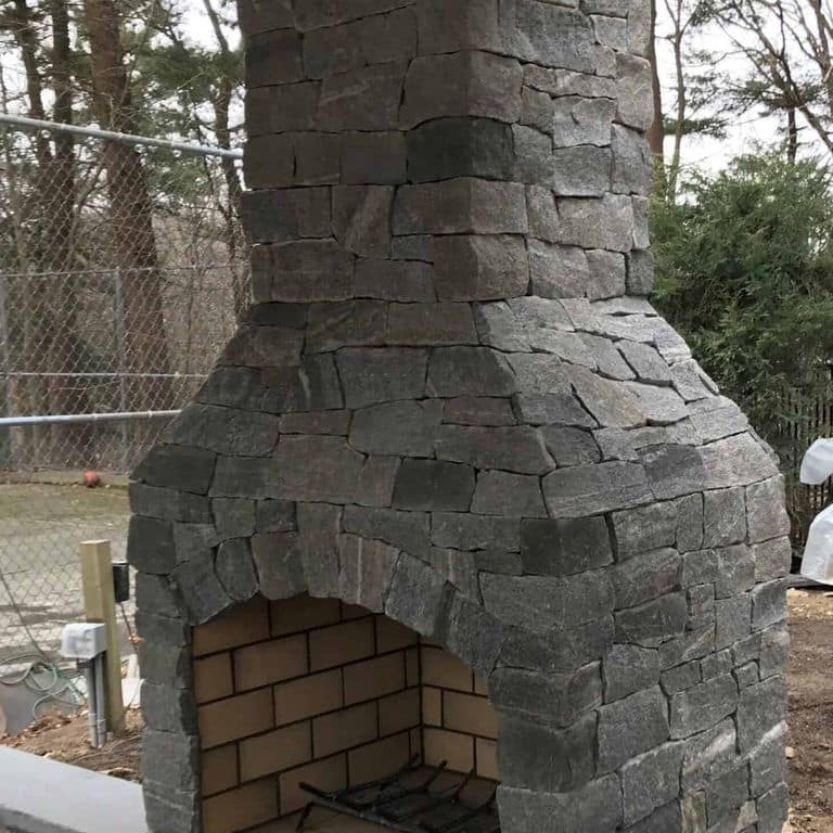 Application image for Oyster Bay Granite Thin Veneer - Ashlar. The image shows this product being used in a thin veneer application. The surface finish shown is split-face. The dominant color shown is gray. The color mix creates a cool feeling.