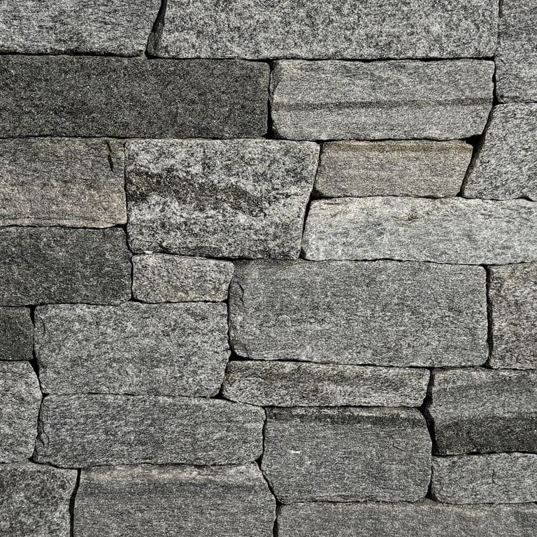 Color/Finish variation image for Oyster Bay Granite Thin Veneer - Ledge. The surface finish shown is split-face. The dominant color shown is gray.