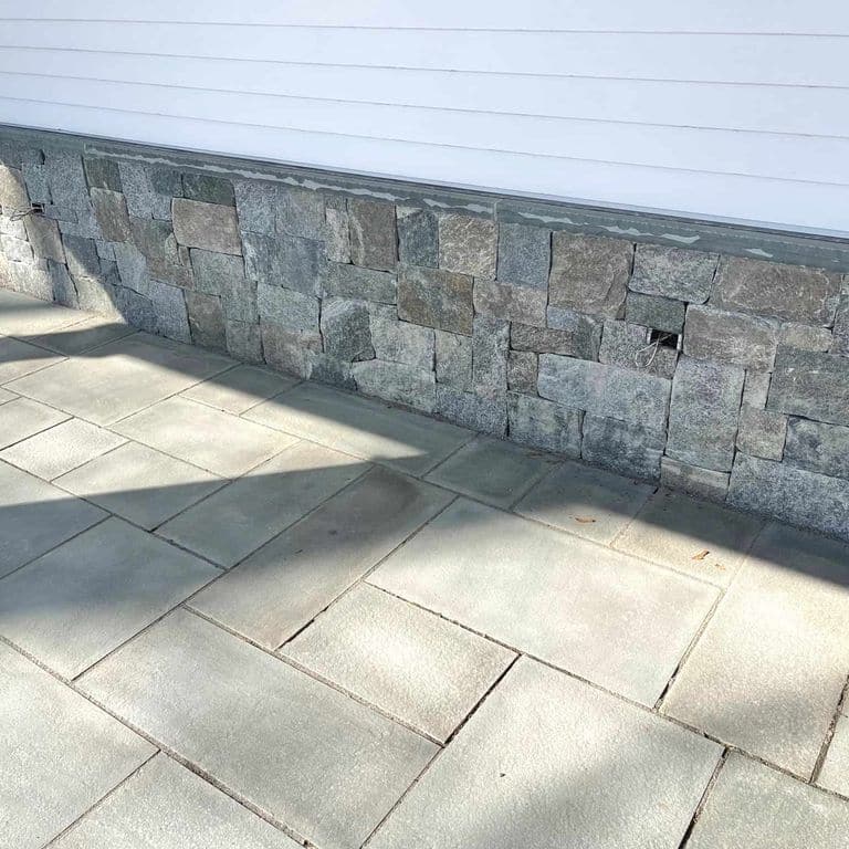 Application image for Oyster Bay Granite Thin Veneer - Square and Rectangle. The image shows this product being used in a thin veneer application. The surface finish shown is . The dominant color shown is gray. The color mix creates a cool feeling.