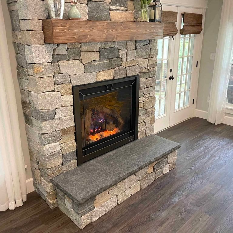 Application image for Boston Blend Granite Thin Veneer - Ashlar. The image shows this product being used in a thin veneer application. The surface finish shown is split-face. Dominant colors shown are gray and tan. The color mix creates a warm feeling.