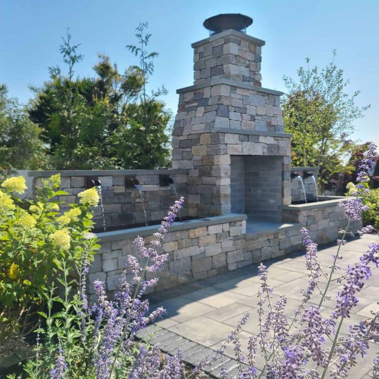 Application image for Boston Blend Granite Thin Veneer - Ashlar. The image shows this product being used in a thin veneer application. The surface finish shown is split-face. Dominant colors shown are gray and tan.