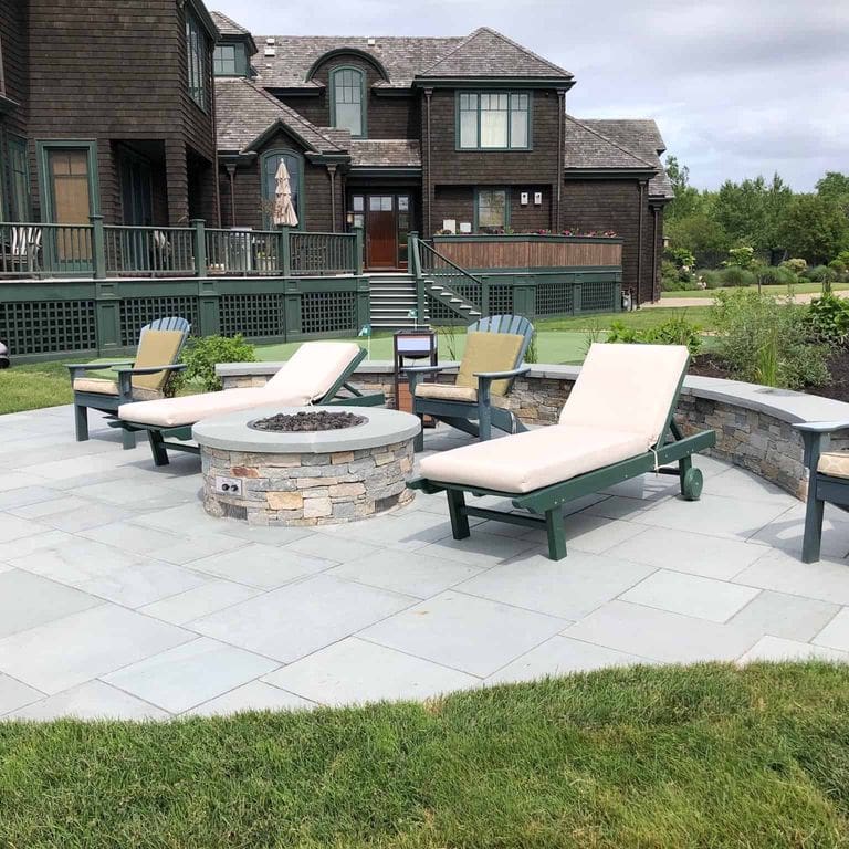 Application image for Boston Blend Granite Veneer - Ledge. The image shows this product being used in a thin veneer application. The surface finish shown is split-face. Dominant colors shown are gray and tan. The color mix creates a warm feeling.