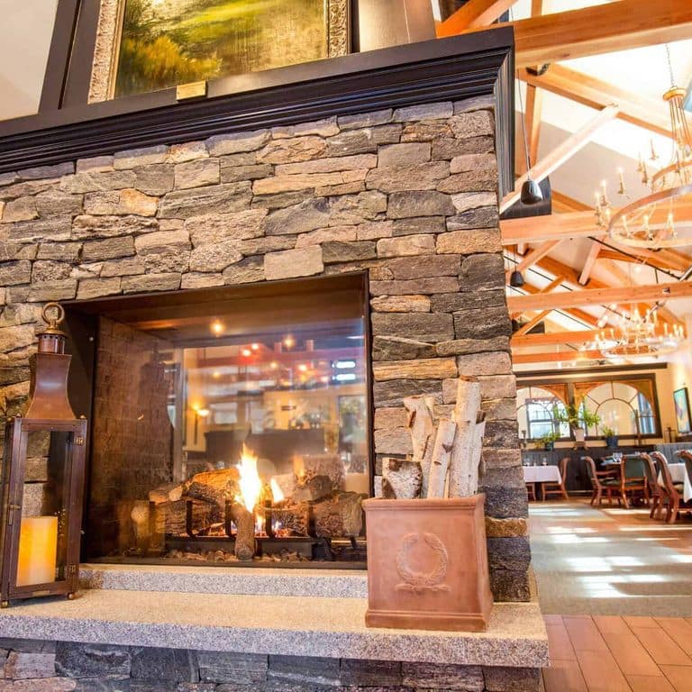 Application image for Boston Blend Granite Veneer - Ledge. The image shows this product being used in a thin veneer application. The surface finish shown is split-face. Dominant colors shown are gray and tan. The color mix creates a warm feeling.