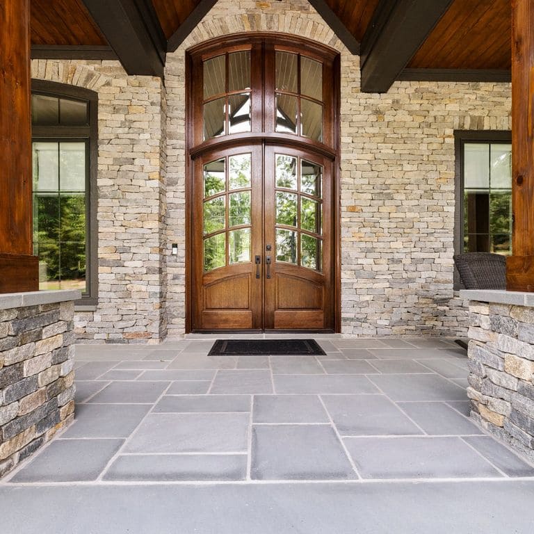 Application image for Boston Blend Granite Veneer - Ledge. The image shows this product being used in a full bed veneer application. The surface finish shown is split-face. The dominant color shown is gray. The color mix creates a warm feeling.