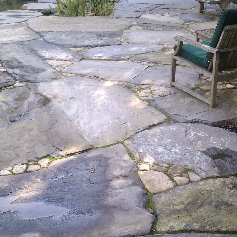 The image shows this product being used in a patio pavers application.