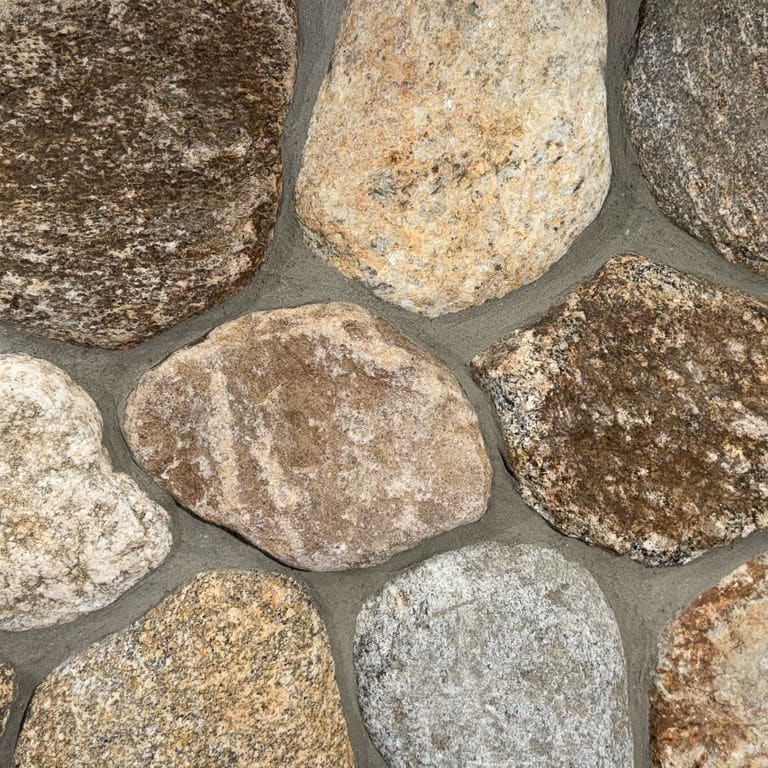 Color/Finish variation image for Boston Blend Granite Veneer - Rounds. The surface finish shown is natural. Dominant colors shown are brown and tan. The color mix creates a warm feeling.