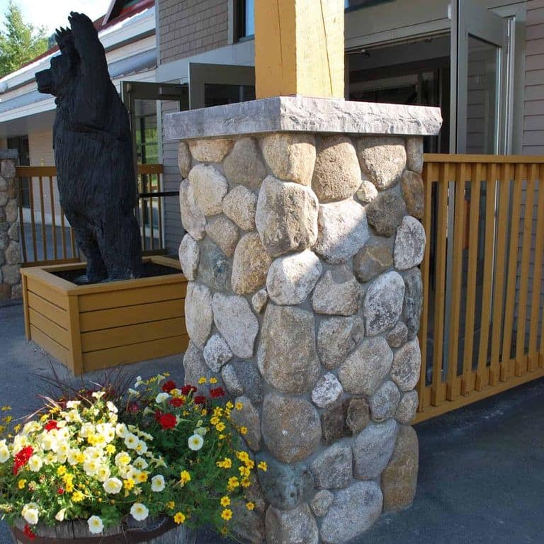 Best close-up image for Boston Blend Granite Veneer - Rounds. The image shows this product being used in a thin veneer application. The surface finish shown is . The dominant color shown is gray.