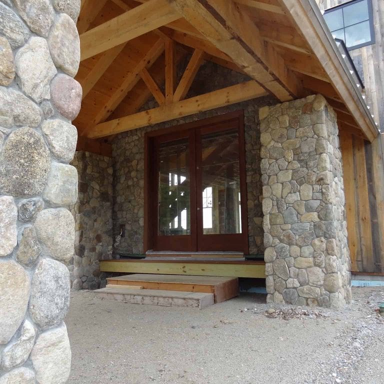 Application image for Boston Blend Granite Veneer - Rounds. The image shows this product being used in a thin veneer application. The surface finish shown is . Dominant colors shown are brown and gray. The color mix creates a warm feeling.