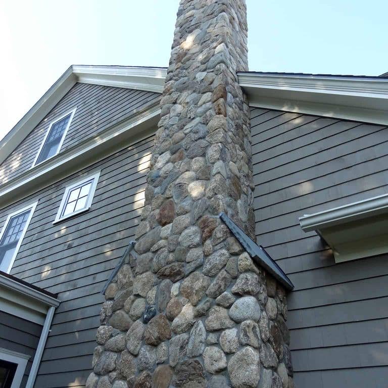 Application image for Boston Blend Granite Veneer - Rounds. The image shows this product being used in a full bed veneer application. The surface finish shown is . Dominant colors shown are gray and tan.