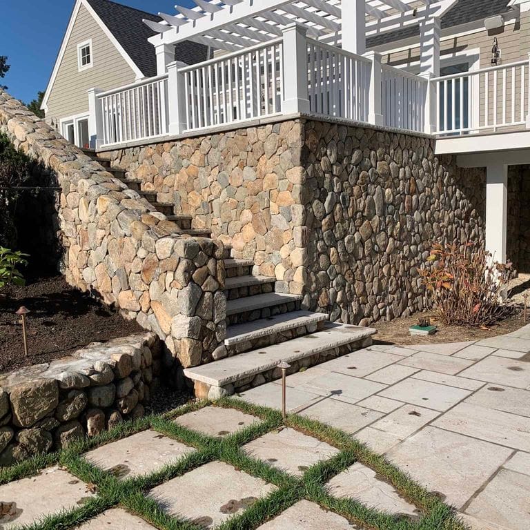 Application image for Boston Blend Granite Veneer - Rounds. The image shows this product being used in a full bed veneer application. The surface finish shown is . Dominant colors shown are brown and tan. The color mix creates a warm feeling.