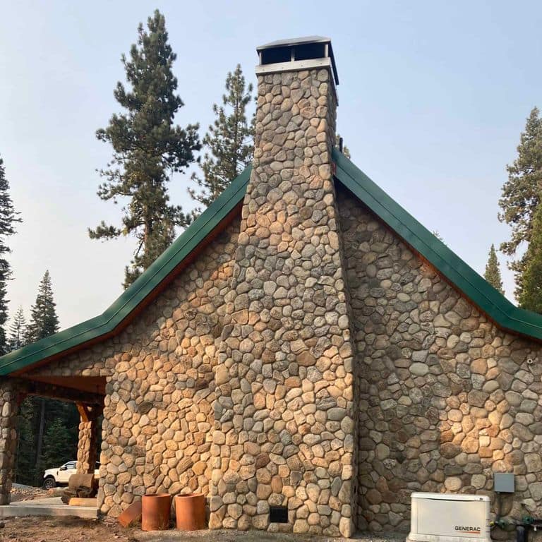 Application image for Boston Blend Granite Veneer - Rounds. The image shows this product being used in a full bed veneer application. The surface finish shown is . Dominant colors shown are brown and gray. The color mix creates a warm feeling.